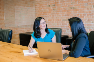 Two women discussing financial plans